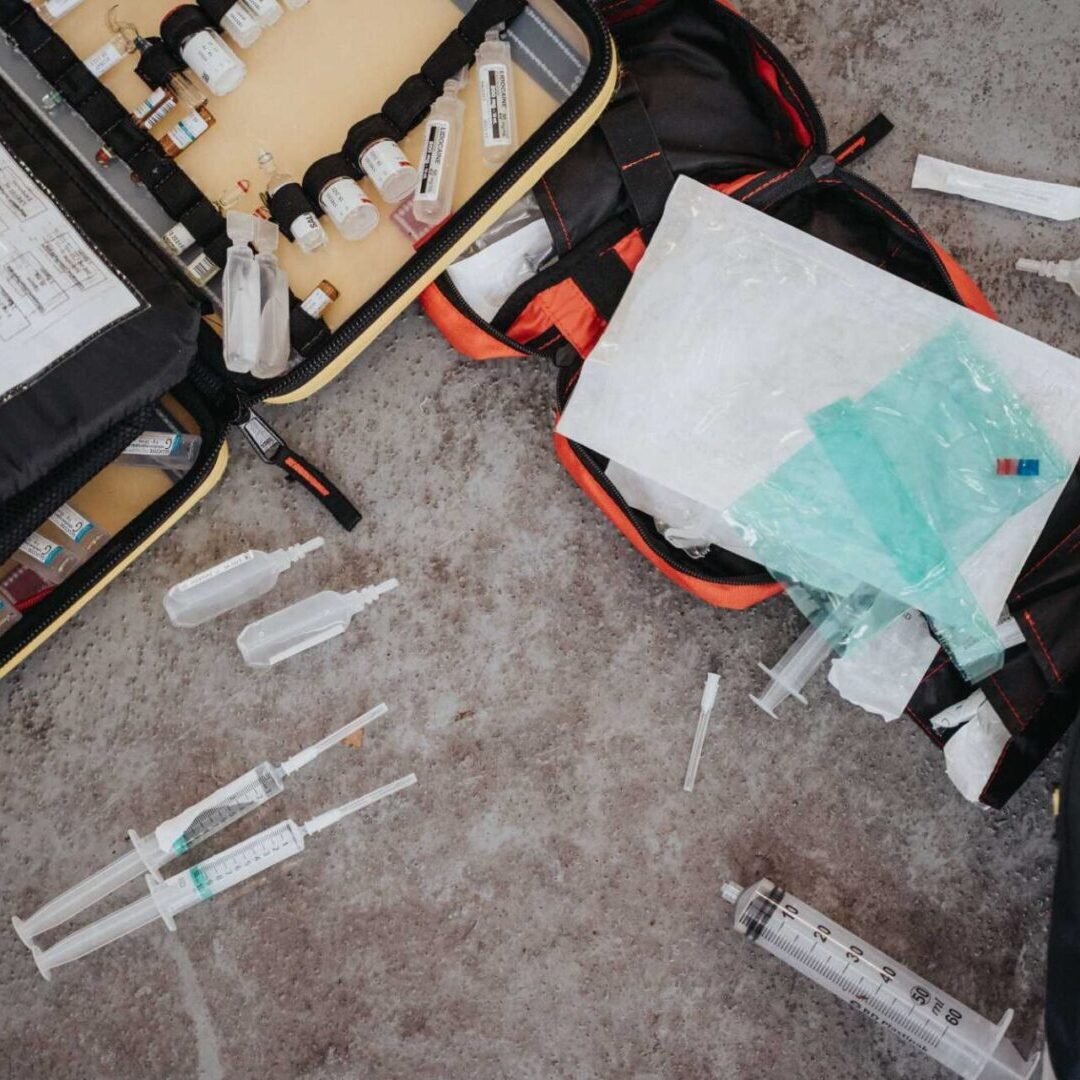 A suitcase filled with medical supplies and a bag