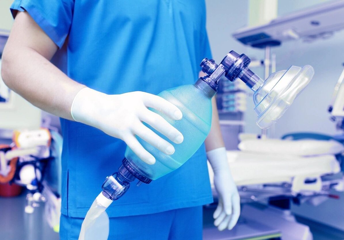 A surgeon holding a bottle of water in his hand.
